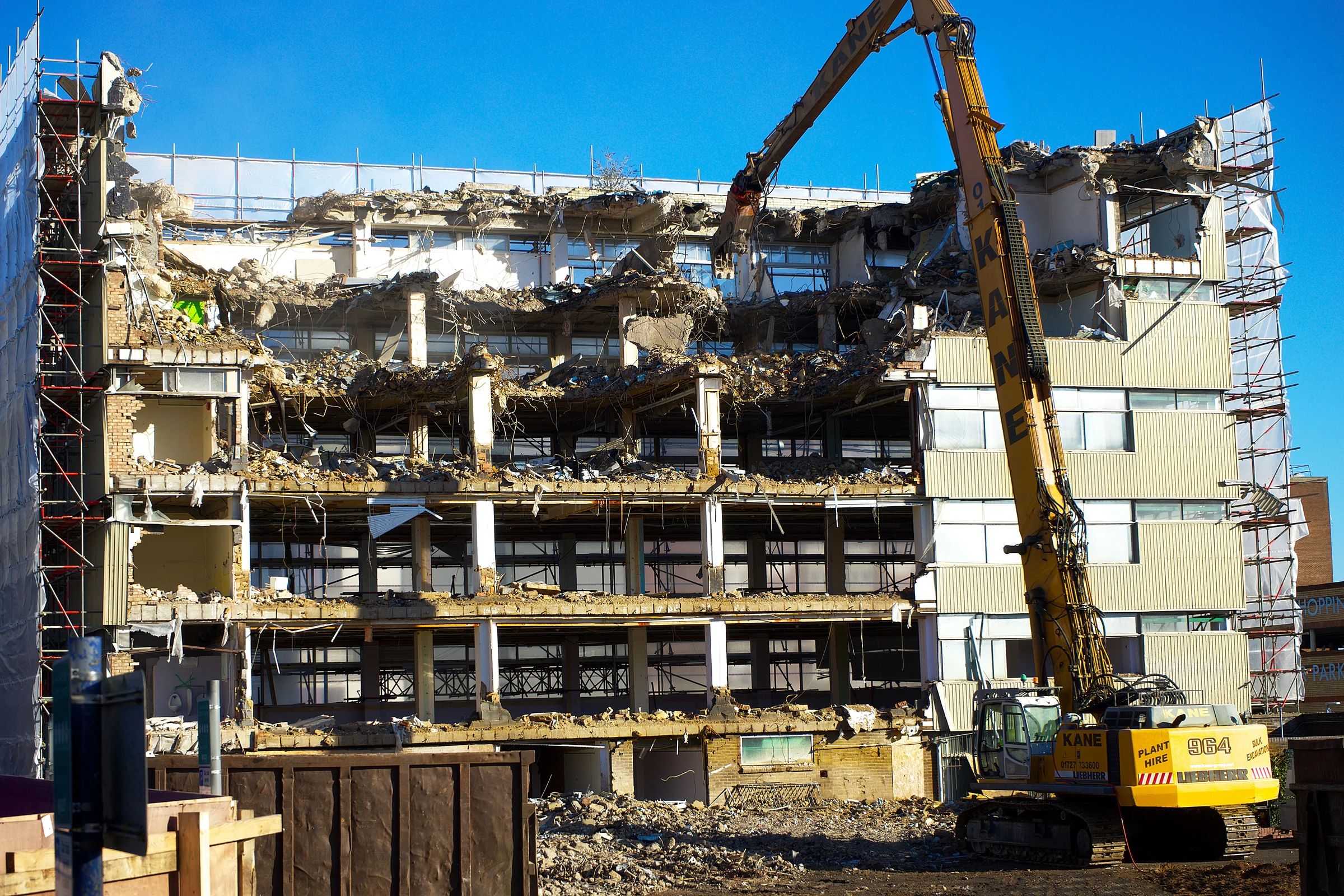 Demolition excavator dismantling a building during controlled site clearance