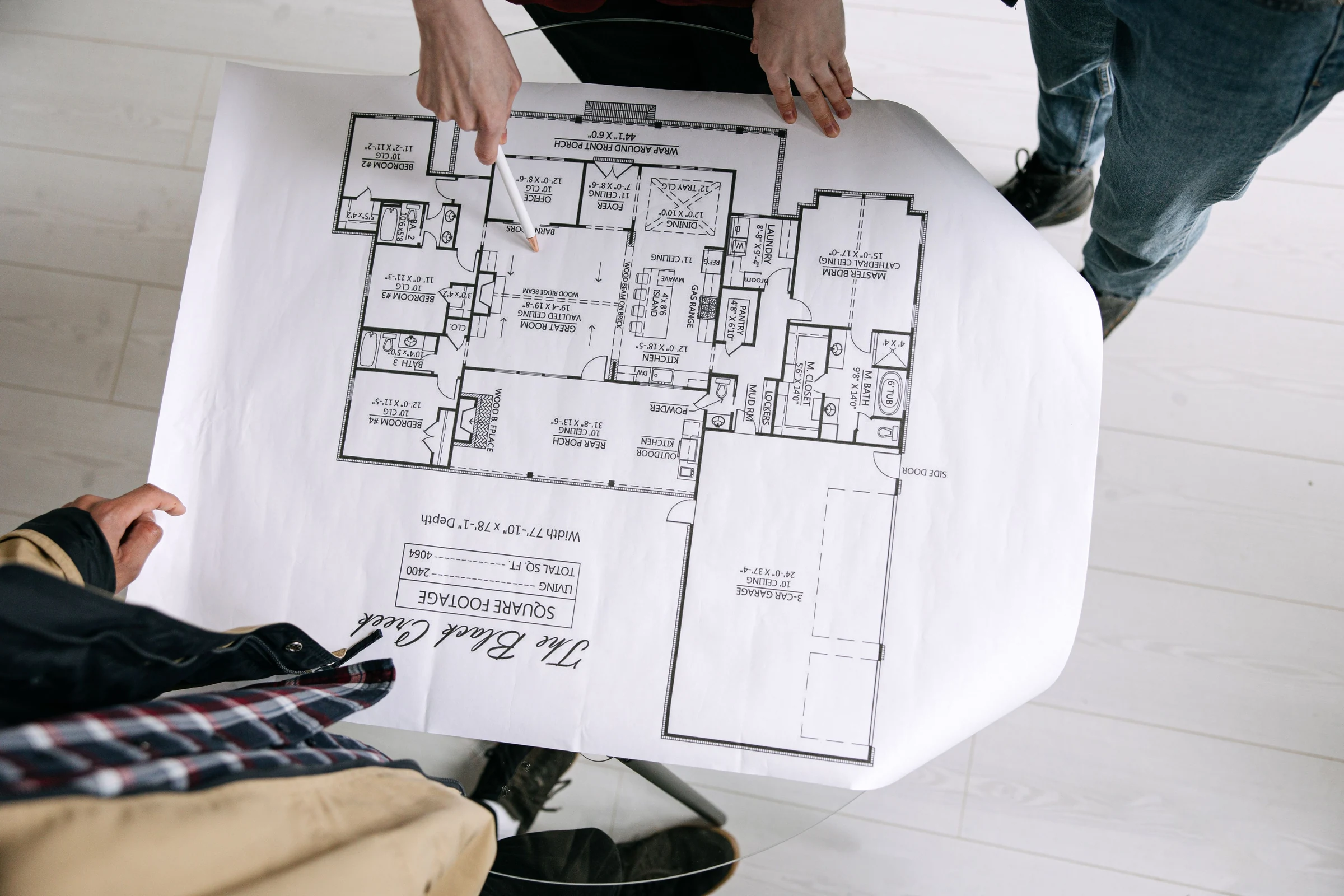 Design team reviewing residential architectural floor plans together