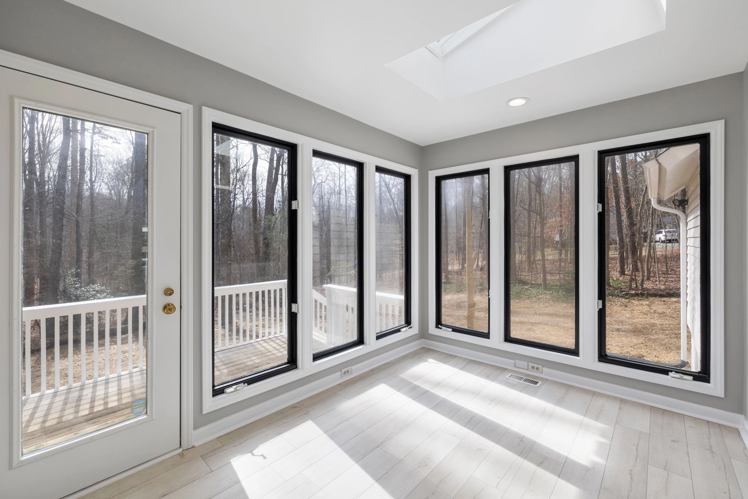 Bright glazed sunroom extension with large windows and garden views