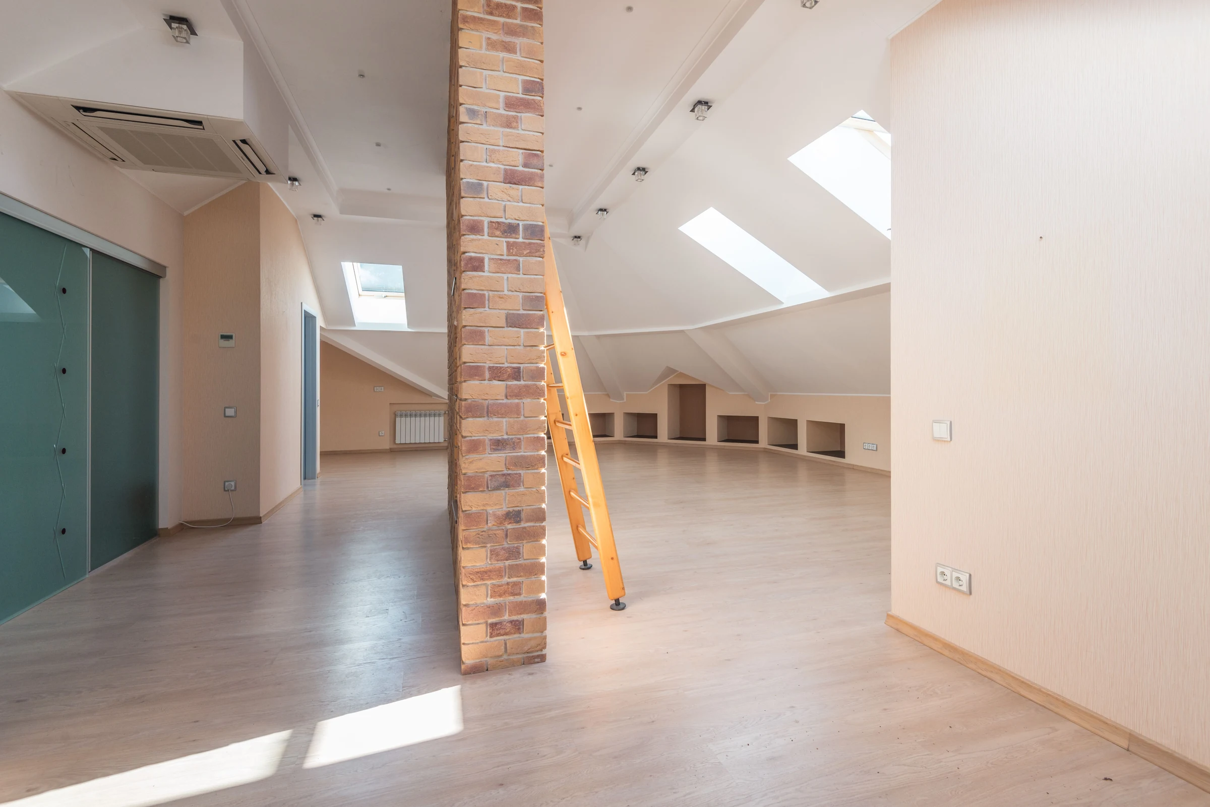 Bright converted loft with sloping ceilings and rooflight windows