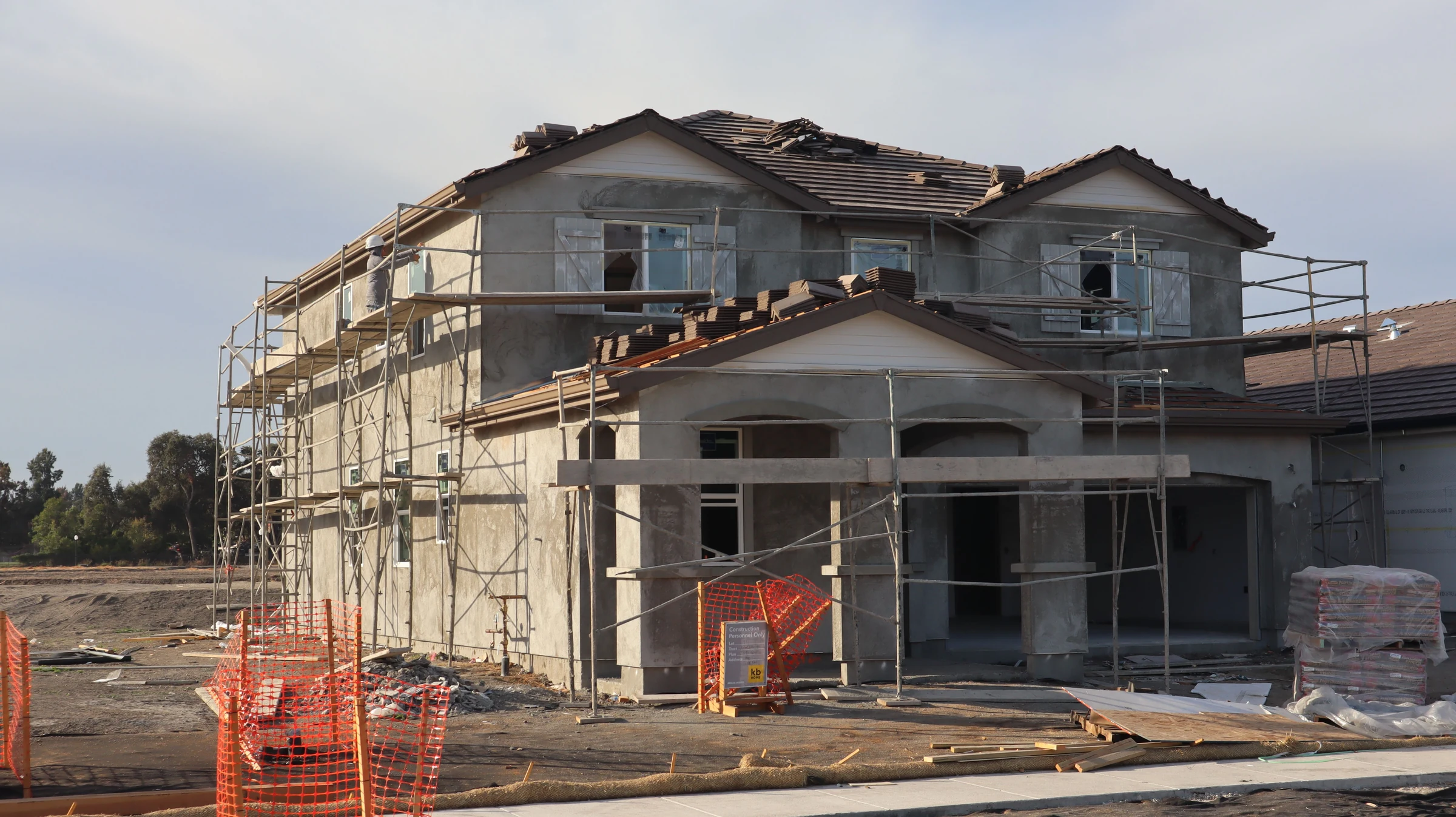 New two-storey residential building under construction with scaffolding